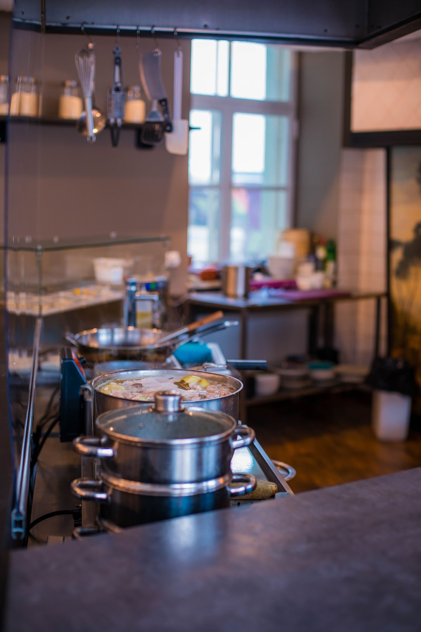 Stainless steel cookware in a working kitchen